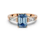 3 Stone Engagement Ring Setting for Fancy Blue Emerald Cut Center with Tapered Baguettes, Plain Band and Prong Head in Rose Gold