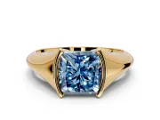 Tension Engagement Ring Setting for Fancy Blue Princess Cut Center with Wide Tapered Band and Tension Head in Yellow Gold