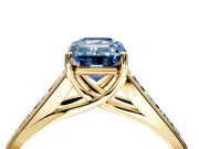 Solitaire Engagement Ring Setting for Fancy Blue Emerald Cut Center with Cathedral Channel Band and Prong Head in Yellow Gold