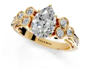 Cluster Engagement Ring Setting for Pear-Shaped Center with Bezel Accent Clusters and Prong Head in Yellow Gold