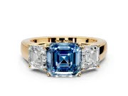 3 Stone Engagement Ring Setting for Fancy Blue Asscher Cut Center with Raised Basket Heads and Prong Head in Yellow Gold