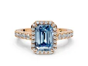 Halo Engagement Ring Setting for Fancy Blue Emerald Cut Center with Full Pave Band and Prong Head in Rose Gold