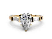 3 Stone Engagement Ring Setting for Pear-Shaped Center with Channel Baguette Accents and Prong Head in Yellow Gold