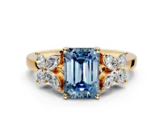 Floral Engagement Ring Setting for Fancy Blue Emerald Cut Center with Marquise Cluster Shoulders and Prong Head in Yellow Gold