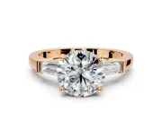 3 Stone Engagement Ring Setting for Round Cut Center with Channel Baguette Accents and Prong Head in Rose Gold