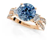 3 Stone Engagement Ring Setting for Fancy Blue Round Cut Center with Pave Twist Band and Prong Head in Rose Gold