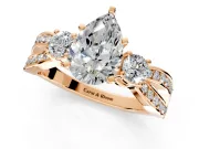 3 Stone Engagement Ring Setting for Pear-Shaped Center with Pave Twist Band and Prong Head in Rose Gold