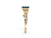 Leaf Motif Engagement Ring Setting for Fancy Blue Emerald Cut Center with Pave Band and Prong Head in Yellow Gold