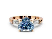 3 Stone Engagement Ring Setting for Fancy Blue Heart-Shaped Center with Channel Baguette Accents and Prong Head in Rose Gold