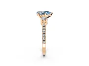 3 Stone Engagement Ring Setting for Fancy Blue Pear-Shaped Center with Round Cut Side Accents and Prong Head in Rose Gold