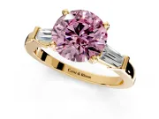 3 Stone Engagement Ring Setting for Fancy Pink Round Cut Center with Channel Baguette Accents and Prong Head in Yellow Gold