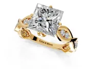 Solitaire Engagement Ring Setting for Princess Cut Center with Accented Twist Band and Leaf Prong Head in Yellow Gold