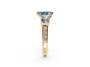 Channel-Set Engagement Ring Setting for Fancy Blue Pear-Shaped Center with Baguette Band and Prong Head in Yellow Gold