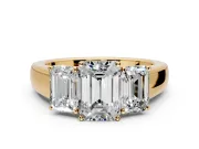 3 Stone Engagement Ring Setting for Emerald Cut Center with Raised Basket Heads and Prong Head in Yellow Gold