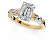 3 Stone Engagement Ring Setting for Emerald Cut Center with Tapered Baguettes, Plain Band and Prong Head in Yellow Gold