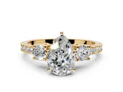 3 Stone Engagement Ring Setting for Pear-Shaped Center with Round Cut Side Accents and Prong Head in Yellow Gold