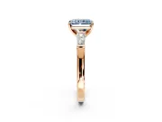 3 Stone Engagement Ring Setting for Fancy Blue Radiant Cut Center with Tapered Baguettes, Plain Band and Prong Head in Rose Gold