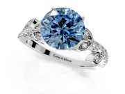 Leaf Motif Engagement Ring Setting for Fancy Blue Round Cut Center with Pave Band and Prong Head in Platinum