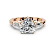 3 Stone Engagement Ring Setting for Heart-Shaped Center with Baguette Accents and Prong Head in Rose Gold