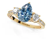 3 Stone Engagement Ring Setting for Fancy Blue Pear-Shaped Center with Round Cut Side Accents and Prong Head in Yellow Gold