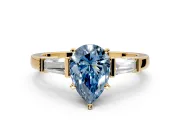 3 Stone Engagement Ring Setting for Fancy Blue Pear-Shaped Center with Channel Baguette Accents and Prong Head in Yellow Gold