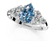 Cluster Engagement Ring Setting for Fancy Blue Pear-Shaped Center with Round Cut Accent Frame and Prong Head in Sterling Silver