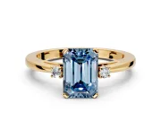 3 Stone Engagement Ring Setting for Fancy Blue Emerald Cut Center with Low-Set Round Cut Accents and Prong Head in Yellow Gold