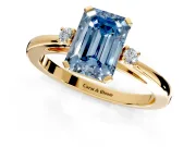 3 Stone Engagement Ring Setting for Fancy Blue Emerald Cut Center with Low-Set Round Cut Accents and Prong Head in Yellow Gold