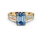 Solitaire Engagement Ring Setting for Fancy Blue Emerald Cut Center with Round Cut Channel Band and Prong Head in Yellow Gold