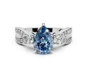 3 Stone Engagement Ring Setting for Fancy Blue Pear-Shaped Center with Pave Twist Band and Prong Head in Platinum