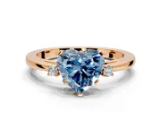 3 Stone Engagement Ring Setting for Fancy Blue Heart-Shaped Center with Low-Set Round Cut Accents and Prong Head in Rose Gold