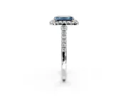 Halo Engagement Ring Setting for Fancy Blue Emerald Cut Center with Narrowing Pave Band and Prong Head in Platinum