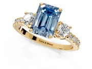 3 Stone Engagement Ring Setting for Fancy Blue Emerald Cut Center with Round Cut Side Accents and Prong Head in Yellow Gold