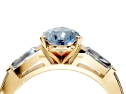 3 Stone Engagement Ring Setting for Fancy Blue Pear-Shaped Center with Tapered Baguettes, Plain Band and Prong Head in Yellow Gold