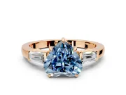 3 Stone Engagement Ring Setting for Fancy Blue Heart-Shaped Center with Baguette Accents and Prong Head in Rose Gold