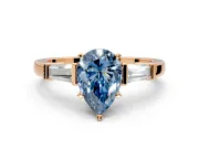 3 Stone Engagement Ring Setting for Fancy Blue Pear-Shaped Center with Channel Baguette Accents and Prong Head in Rose Gold