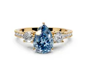 3 Stone Engagement Ring Setting for Fancy Blue Pear-Shaped Center with Round Cut Side Accents and Prong Head in Yellow Gold