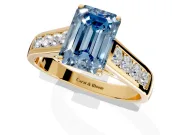 Solitaire Engagement Ring Setting for Fancy Blue Emerald Cut Center with Cathedral Channel Band and Prong Head in Yellow Gold
