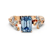 Floral Engagement Ring Setting for Fancy Blue Emerald Cut Center with Trailing Marquise Accents and Prong Head in Rose Gold