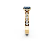 Solitaire Engagement Ring Setting for Fancy Blue Emerald Cut Center with Channel-Set Accents and Prong Head in Yellow Gold