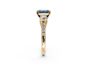 3 Stone Engagement Ring Setting for Fancy Blue Emerald Cut Center with Crossover Basket, Pave Band and Prong Head in Yellow Gold
