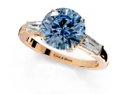 3 Stone Engagement Ring Setting for Fancy Blue Round Cut Center with Baguette Accents and Prong Head in Rose Gold