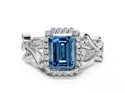 Halo Engagement Ring Setting for Fancy Blue Emerald Cut Center with Leaf Motif Split Shank and Prong Head in Platinum