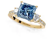 3 Stone Engagement Ring Setting for Fancy Blue Princess Cut Center with Round Cut Side Accents and Prong Head in Yellow Gold