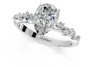 Cluster Engagement Ring Setting for Pear-Shaped Center with Round Cut Accent Band and Prong Head in Platinum