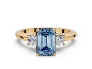 3 Stone Engagement Ring Setting for Fancy Blue Emerald Cut Center with Wide Plain Band and Prong Head in Yellow Gold