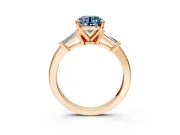 3 Stone Engagement Ring Setting for Fancy Blue Round Cut Center with Channel Baguette Accents and Prong Head in Rose Gold