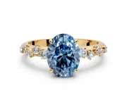 Cluster Engagement Ring Setting for Fancy Blue Oval Center with Round Cut Accent Band and Prong Head in Yellow Gold