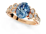 Cluster Engagement Ring Setting for Fancy Blue Oval Center with Bezel Accent Clusters and Prong Head in Rose Gold