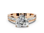 Solitaire Engagement Ring Setting for Heart-Shaped Center with Princess Cut Channel Band and Prong Head in Rose Gold